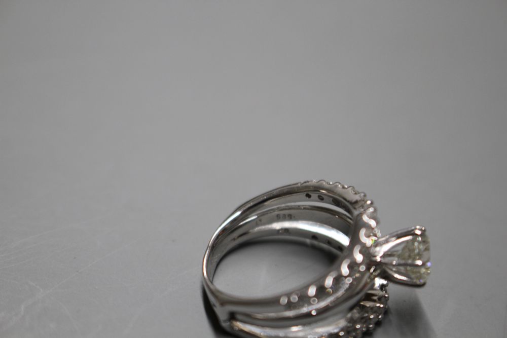 A modern 14kt white metal and triple band diamond dress ring,